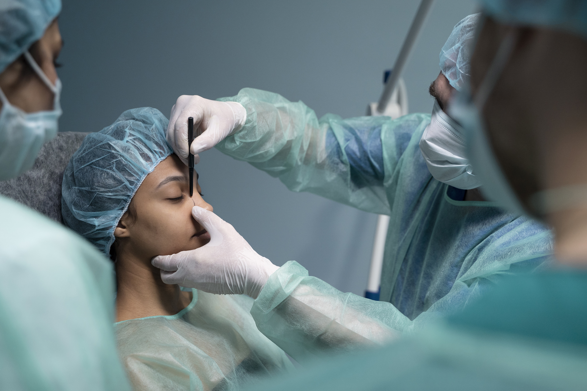 side-view-doctor-checking-patient-before-rhinoplasty